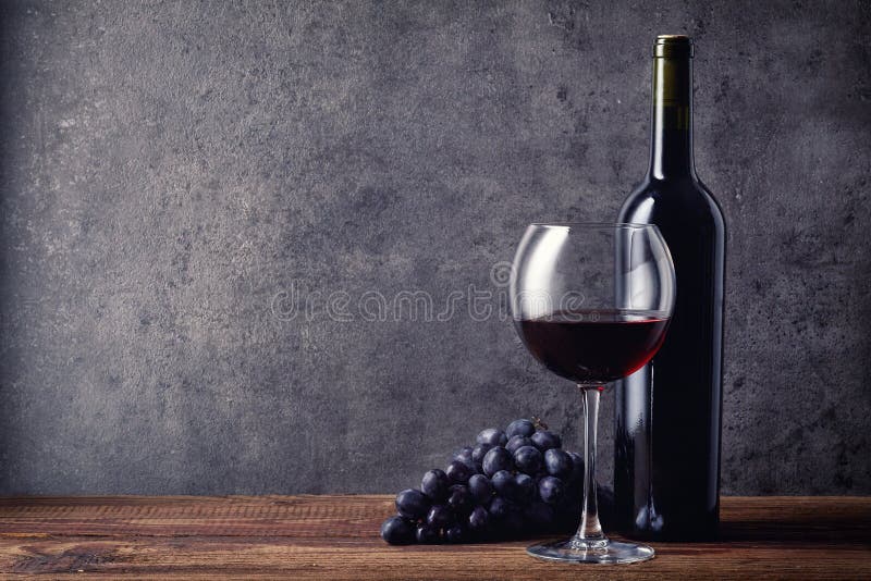 Bottle and glass of red wine and grapes