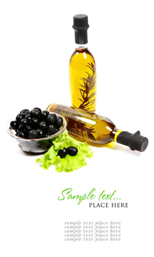 A bottle of olive oil with herbs and black olives