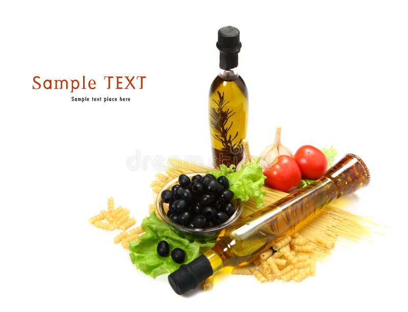 A bottle of olive oil with pasta and black olives