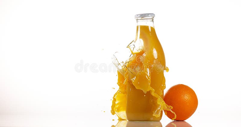 Bottle of Orange Exploding against White Background stock photo