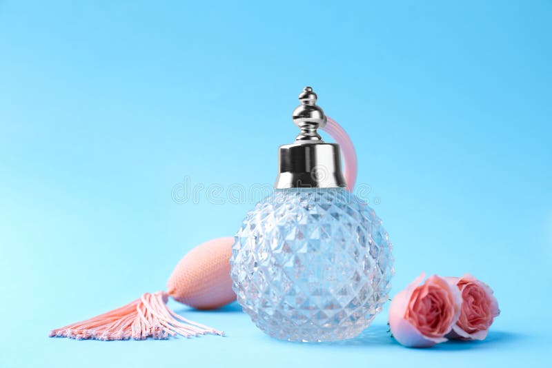 Bottle of Perfume and Flowers on Light Blue Stock Image Image of pink