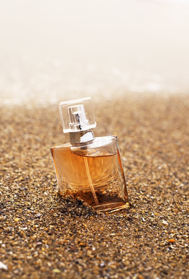 Premium Photo  Blue perfume bottle mock up stands on wet sand on the  background of waves and the sea on the beach