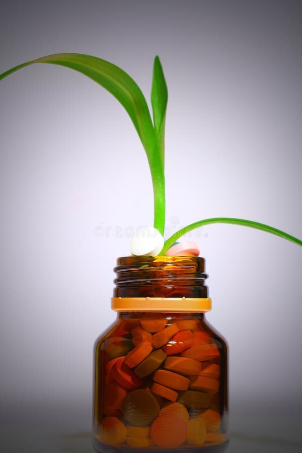 Bottle of pills with growing plant royalty free stock photography Bottle of pills with growing plant royalty free stock photography