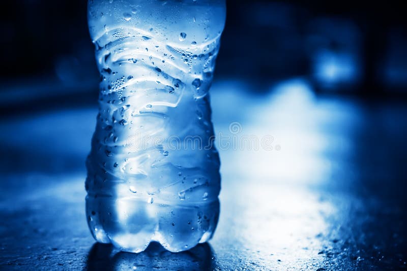 Bottle of Pure Water with Condensate Drops and Back Light Stock Image