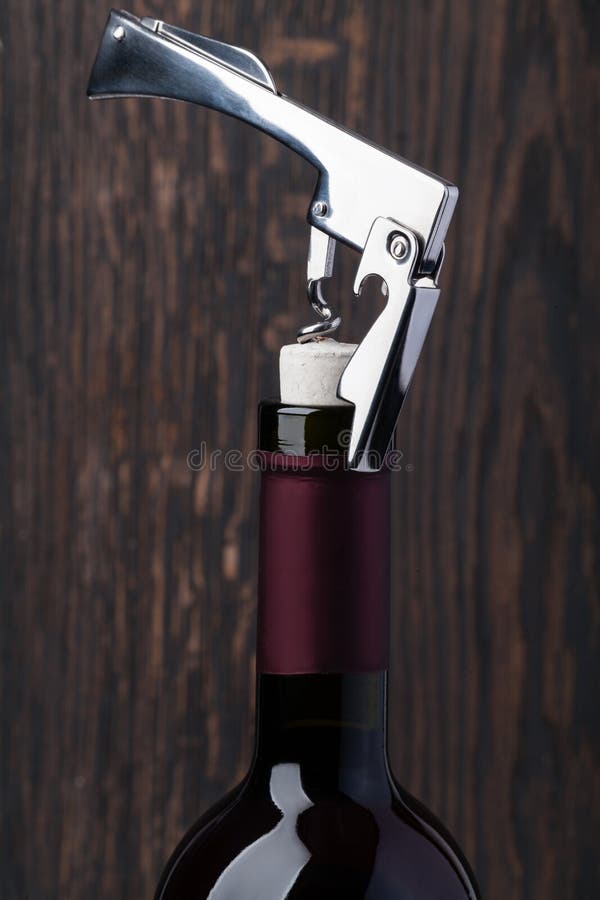 Bottle of red wine and corkscrew