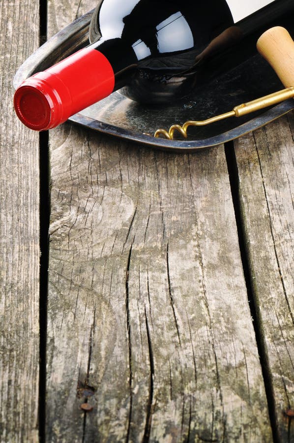 Bottle of red wine and corkscrew stock photos Bottle of red wine and corkscrew stock photos