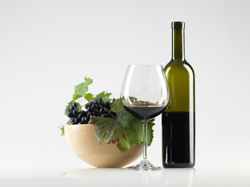 Bottle red wine, glass, grapes white background