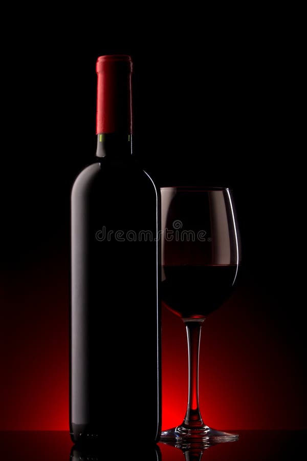 Bottle with red wine and glass on a red gradient