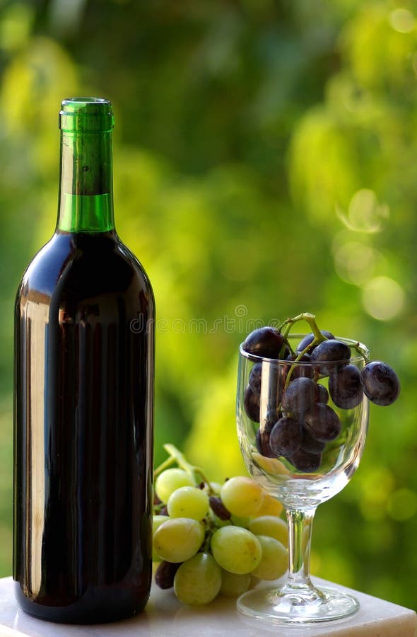 Bottle of red wine and grapes.