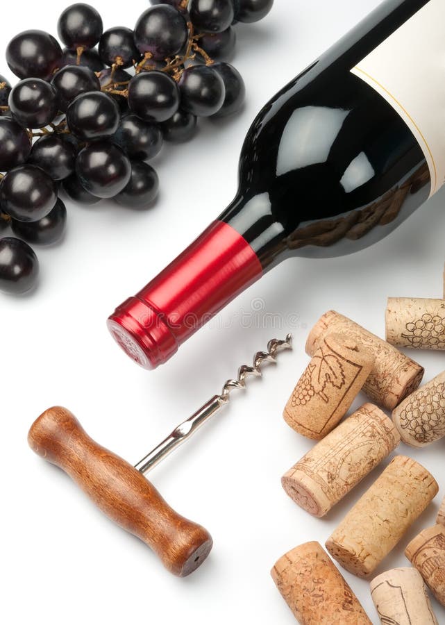 Bottle of red wine, grapes, corkscrew and corks