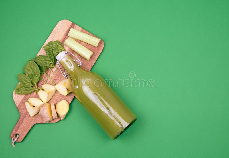 Bottle of Spinach Juice and Table with Vegetables and Fruits Stock