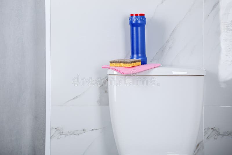 Bottle, Sponge and Cleaning Rag on Toilet Bowl in Bathroom, Space for