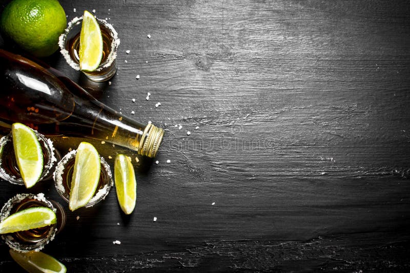 Bottle of Tequila with Shot Glasses, Fresh Lime and Salt. Stock Image