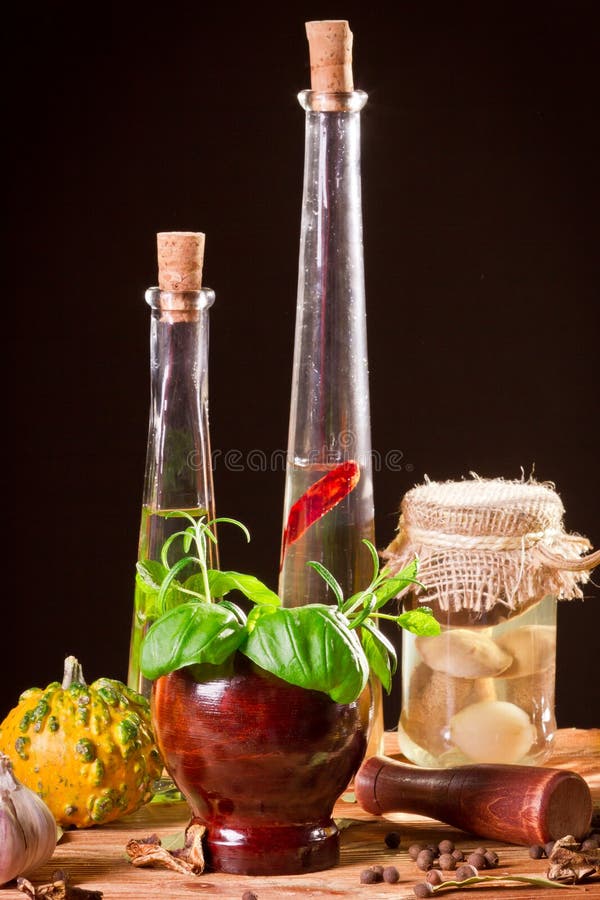 Bottle with vegetable oil and fresh spices