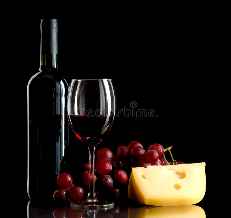 Bottle of wine, a bunch of red grapes and a piece of cheese