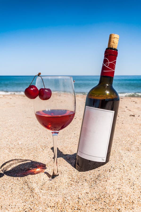 bottle-wine-glass-cherries-sand-beach-ne