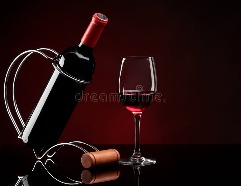 Bottle with wine on a stand and glass stock image