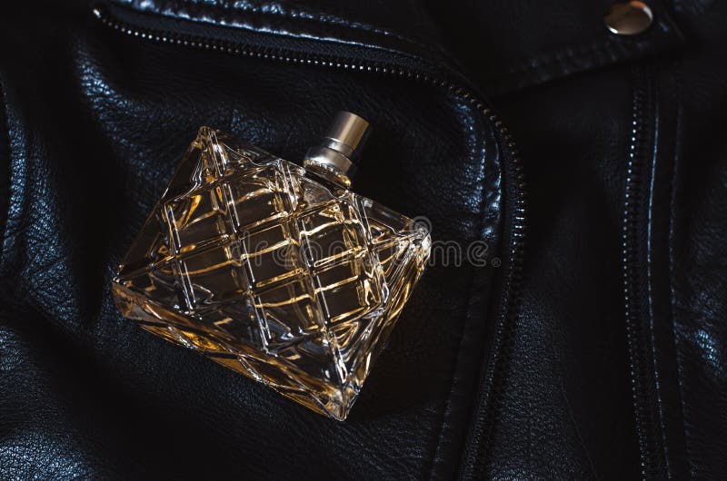 A Bottle of Women S Perfume on a Black Leather Jacket Stock Image