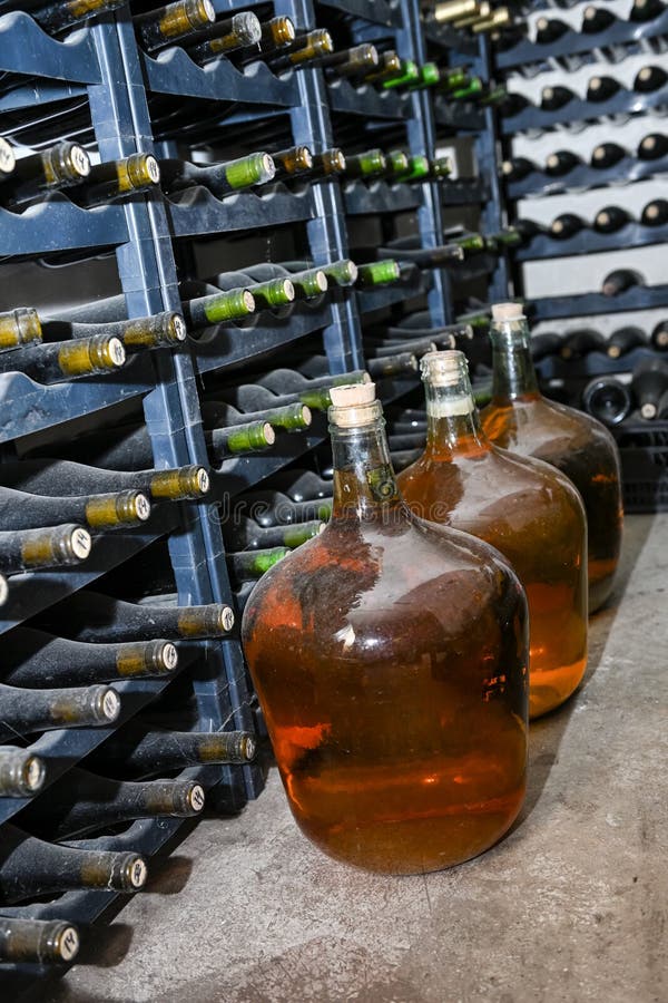Bottled Wines on the Shelves Inside an Underground Cellar Stock Photo