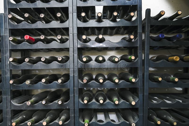 Bottled Wines on the Shelves Inside an Underground Cellar Stock Photo