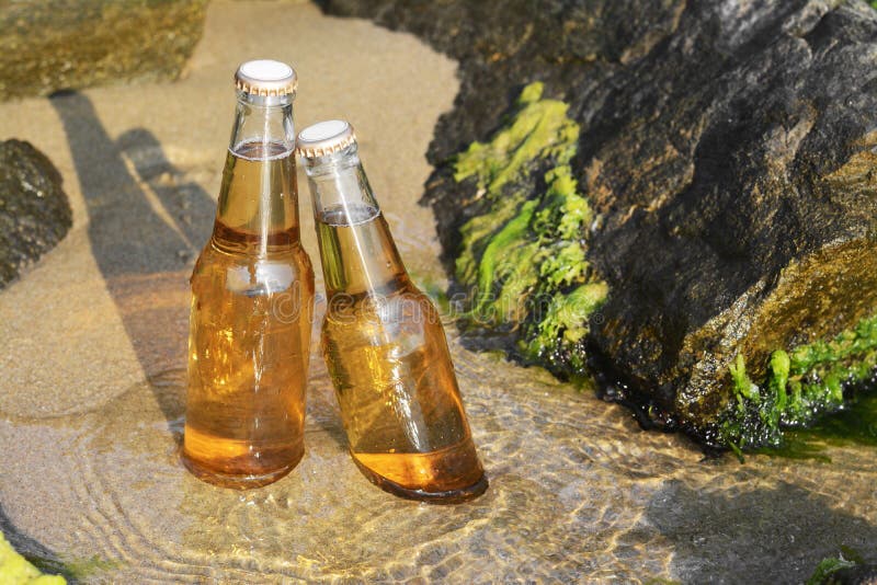 Bottles of Cold Beer Near Rock on Sandy Beach Stock Image Image of