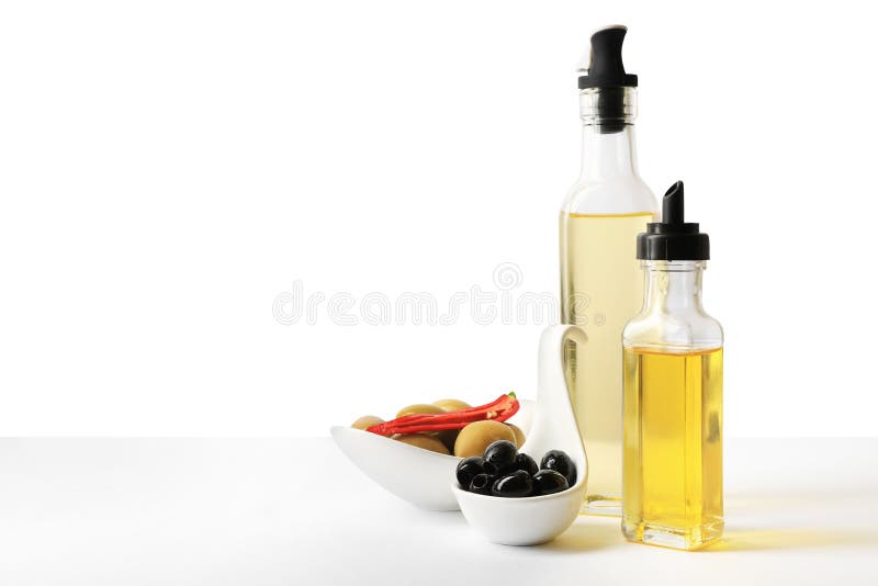 Bottles of Different Cooking Oils and Olives on White Background Stock