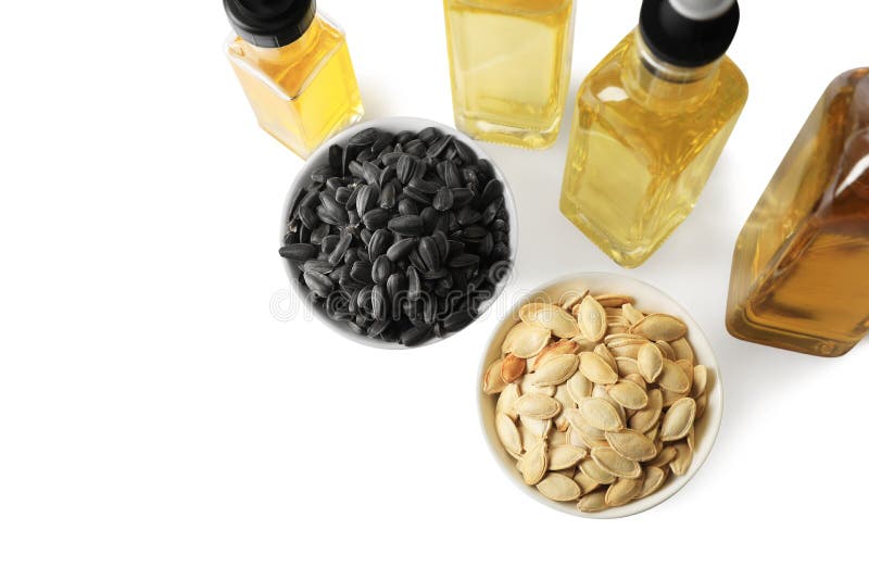 Bottles of Different Cooking Oils and Seeds on White Background, Above