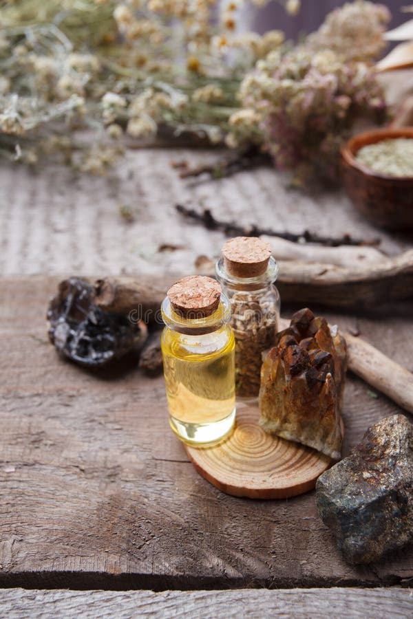 Bottles with emulsion, stones and wooden details. Occult, esoteric, divination and wicca concept. Mystic, old apothecary royalty free stock photography Bottles with emulsion, stones and wooden details. Occult, esoteric, divination and wicca concept. Mystic, old apothecary royalty free stock photography