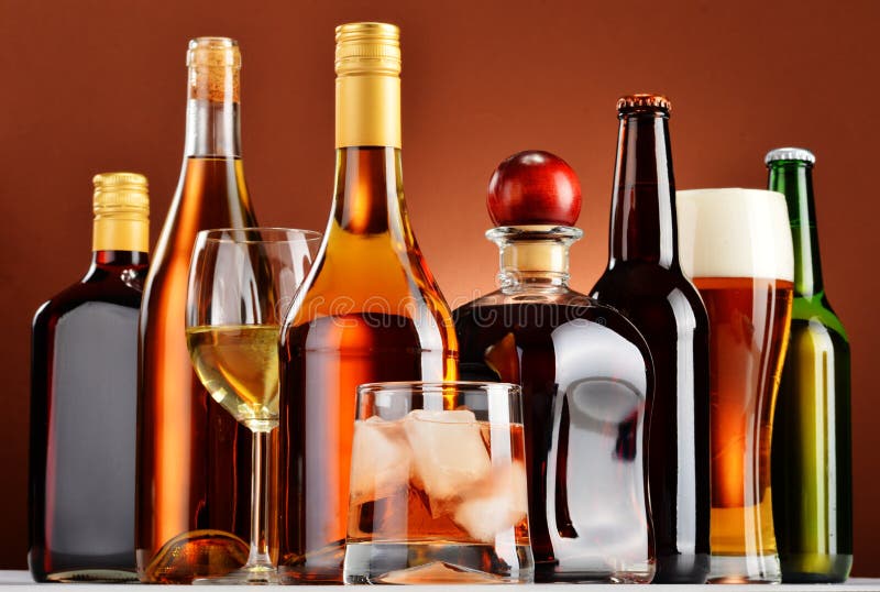 Bottles and Glasses of Assorted Alcoholic Beverages Over White Stock