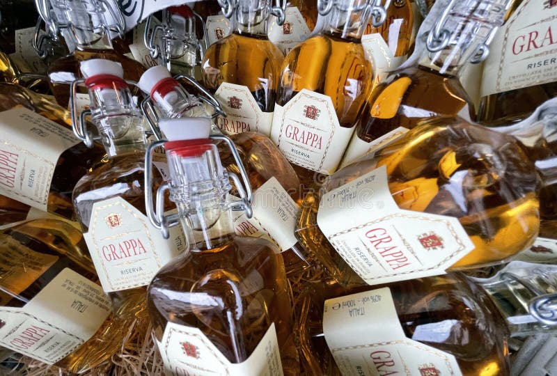 bottles of grappa in a basket at a market at riva del garda