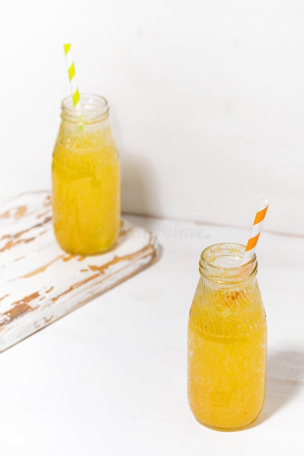 Bottles of Homemade Citrus Lemonade on a White Background, Vertical Top