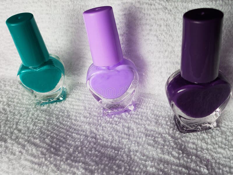 Bottles with Nail Polish in Aquamarine, Pink and Purple, with White ...