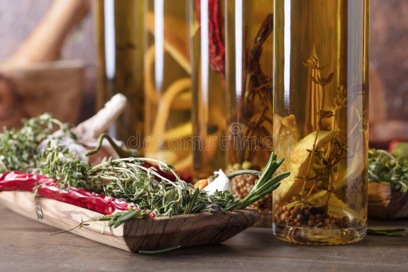 Bottles of Olive Oil with Different Spices and Herbs. Stock Photo