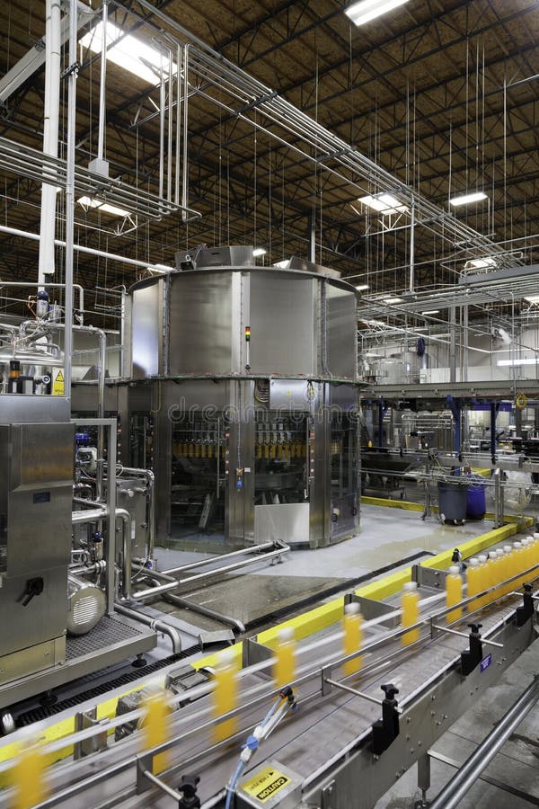 Bottles on production line at bottling plant royalty free stock images