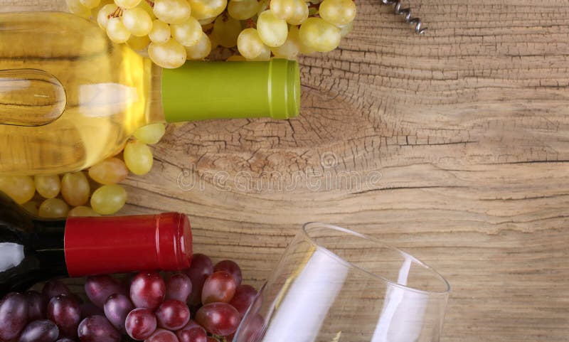 Bottles of red and white wine on old wood royalty free stock images