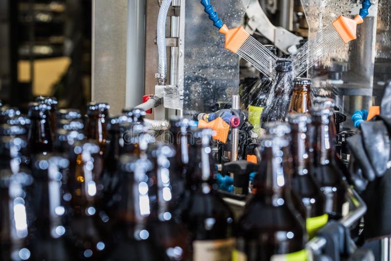 Bottles washing on conveyor royalty free stock photos