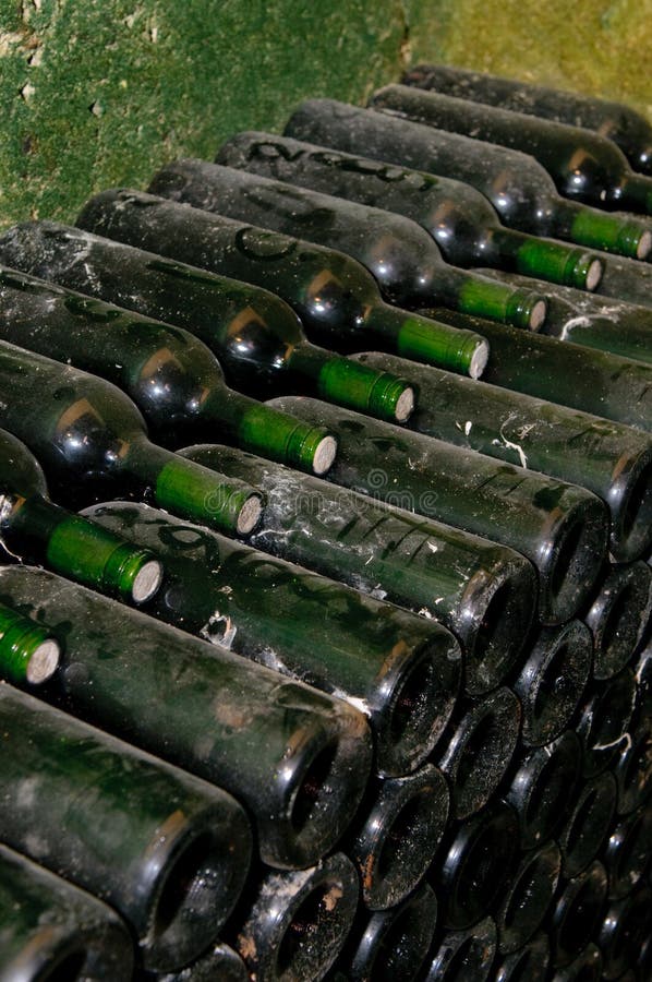 Old bottles in wine cellar stock photo. Image of cellar 10358026