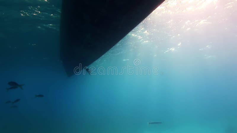 Bottom of boat out of water on background of sun