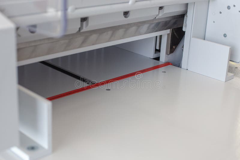 Bottom View of Metal Knife in an Automatic Machine for Cutting Stack of