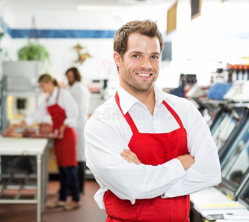 Boucher masculin sûr Standing Arms Crossed à photos stock Boucher masculin sûr Standing Arms Crossed à photos stock