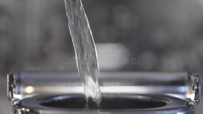 Bouchon d'eau versé dans la bouilloire métallique. action. le flux d'eau propre est versé dans la bouilloire. l'eau est versée clips vidéos