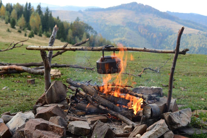 Camp kettle is heated on a fire. Camp kettle is heated on a fire