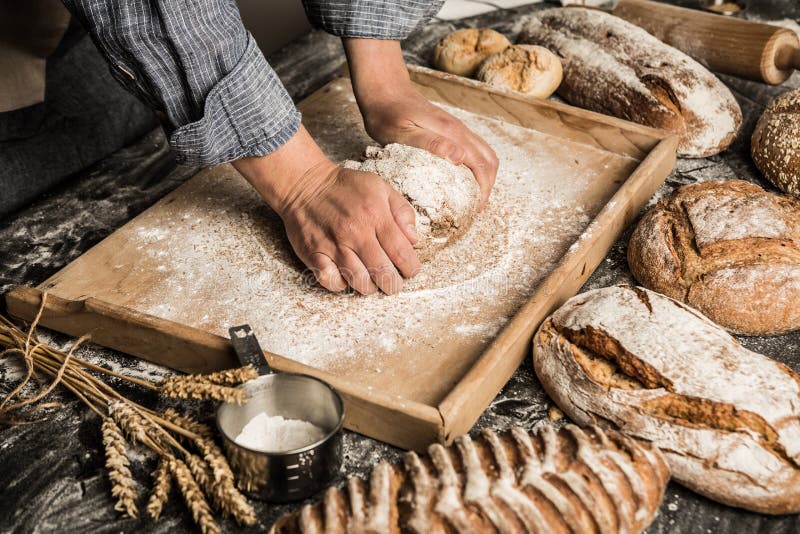 Boulangerie - mains du ` s de boulanger malaxant la pâte crue, faisant le pain