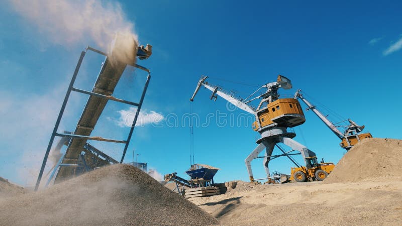 Boulder quarry and loaders transporting gravel. Mining Excavation equiipment.