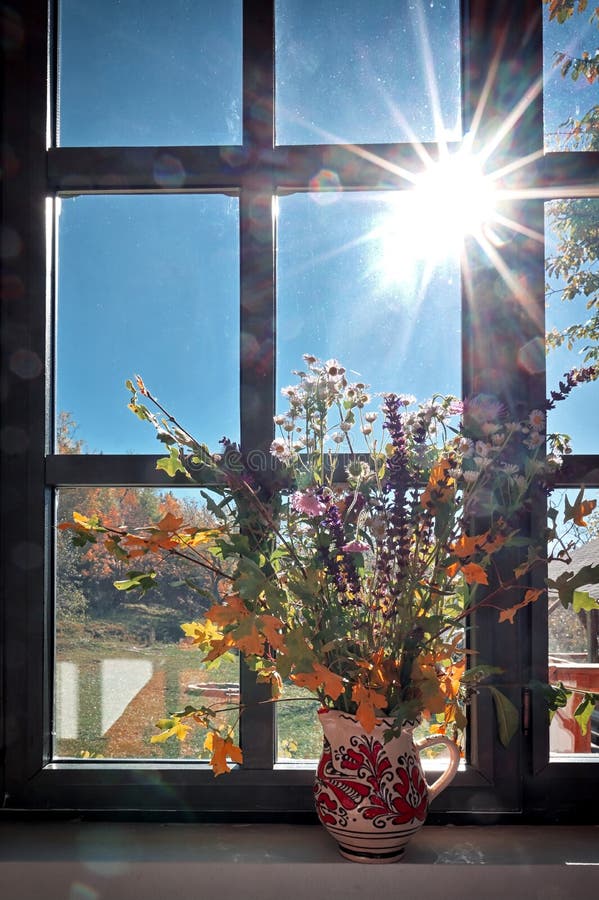 Bouquet of Autumn Flowers and Leaves on the Window Sill Stock Image