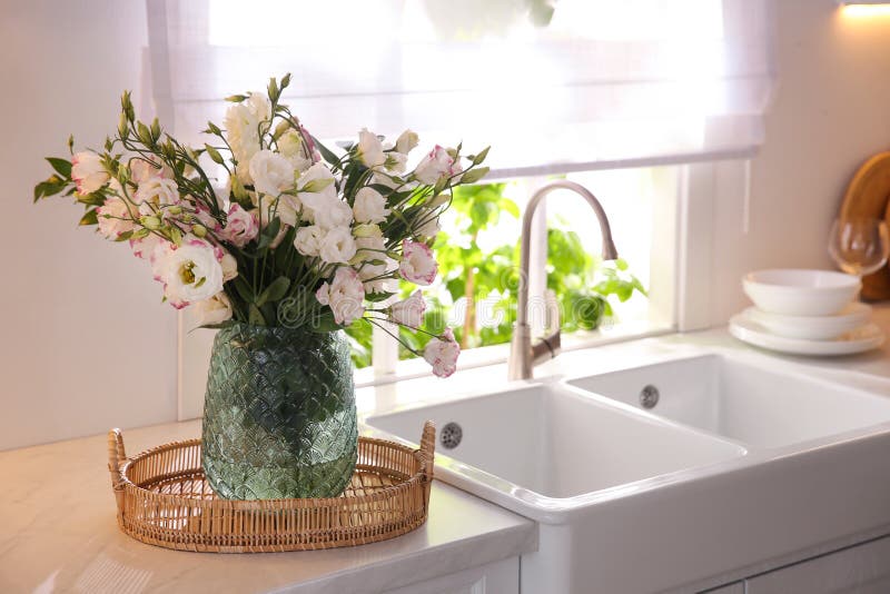 Bouquet of Beautiful Flowers on Countertop in Kitchen, Space for Text