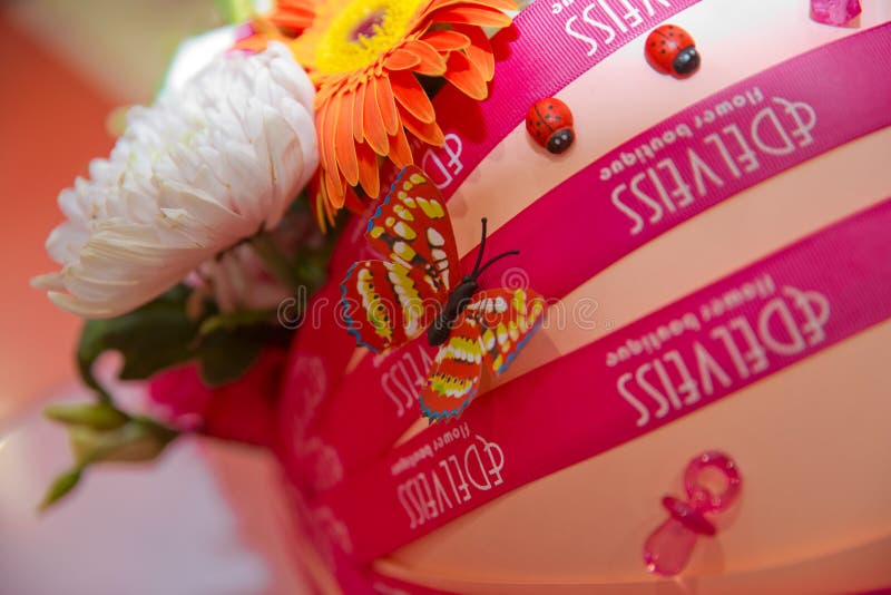 Bouquet for the birth of a child . Carriages bouquet . Colorfull flowers . Yellow and red artificial butterflies stock image Bouquet for the birth of a child . Carriages bouquet . Colorfull flowers . Yellow and red artificial butterflies stock image