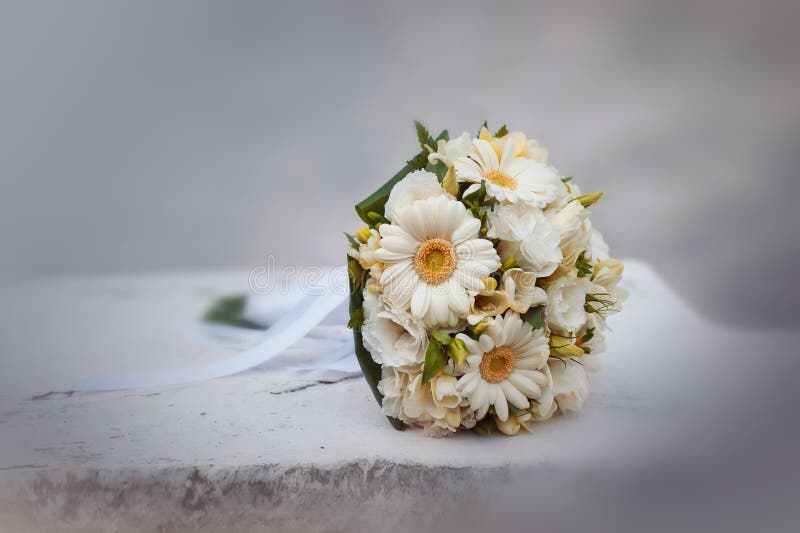 Wedding bouquet from camomiles and roses close up. Wedding bouquet from camomiles and roses close up