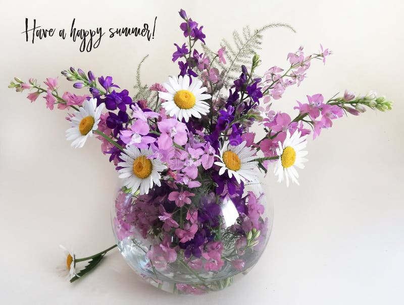 Bouquet of delphinium, chamomile and daylily. Flowers in a bouquet of country style in a glass vase.Holiday card, mother`s day, father`s day, birthday, glass vase, wooden. Happy Birthday! Have a happy summer!