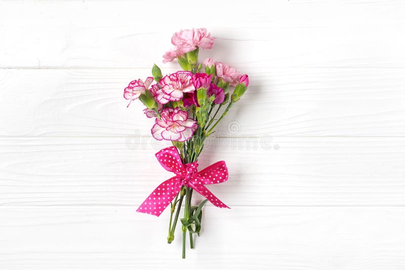 Bouquet of different pink carnation flowers on white wooden background Top view Flat lay Holiday card 8 March, Happy Valentine`s stock image Bouquet of different pink carnation flowers on white wooden background Top view Flat lay Holiday card 8 March, Happy Valentine`s stock image
